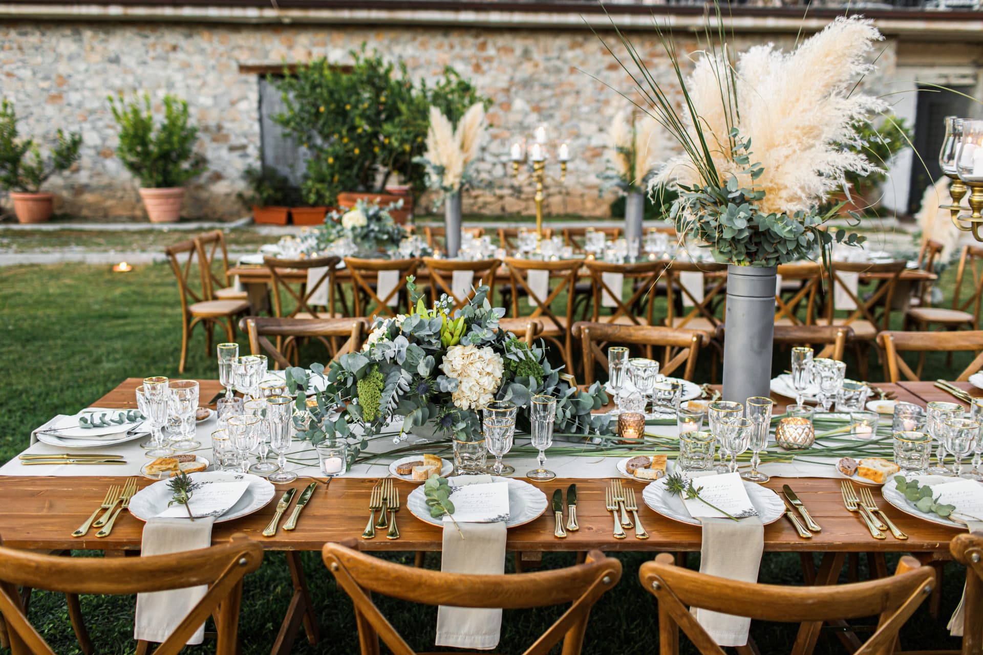Elegant estate table setting with fine linens, candlelight, and floral arrangements